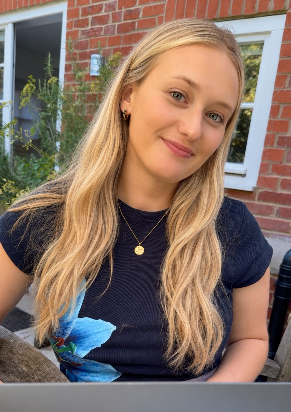 Hannah outdoors in the sun, smiling